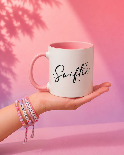 Swiftea mug showing the hand-lettered Swiftie side and blush handle