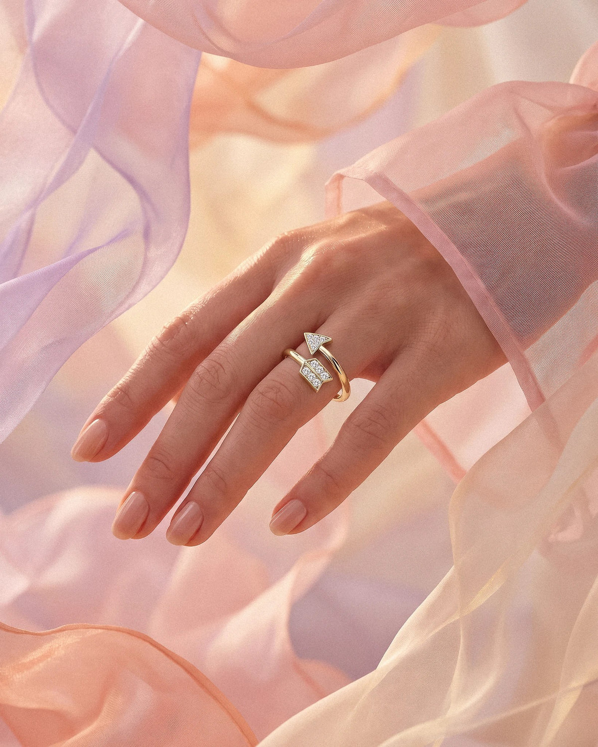 The Archer adjustable arrow ring in gold tone with pave stones
